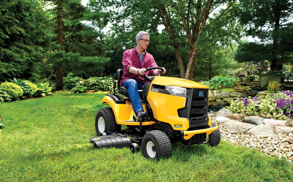 man cutting is lawn with Cub Cadet riding lawn mower