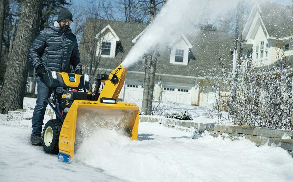 Man snow blowing his driveway