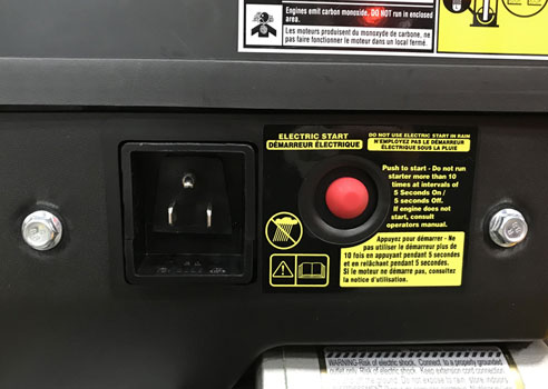 pressing the push button start on the snow blower