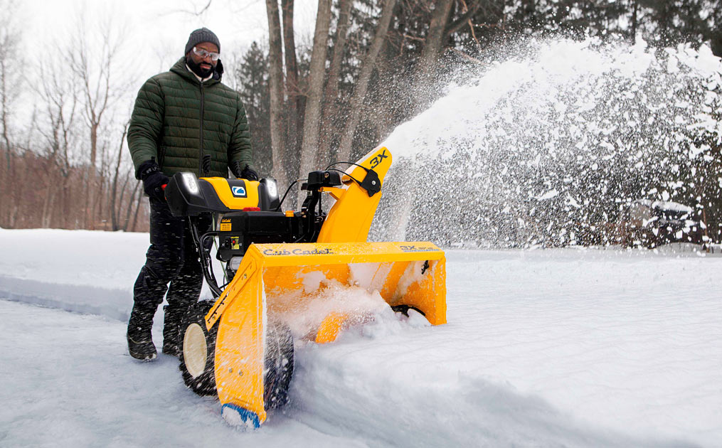 Man snow blowing his driveway