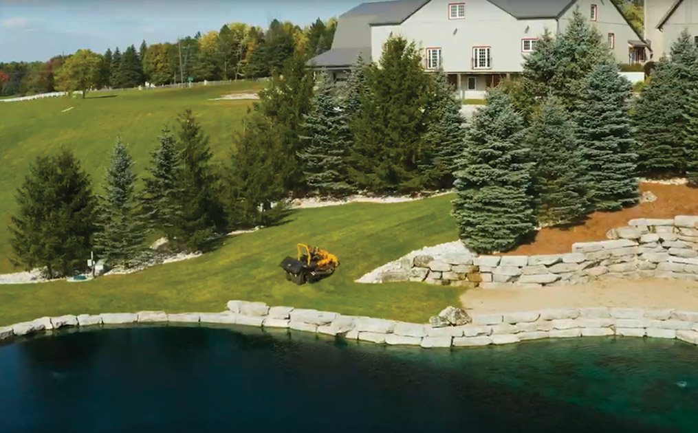 aerial view of Cub Cadet Pro Z mower cutting the grass of a large backyard