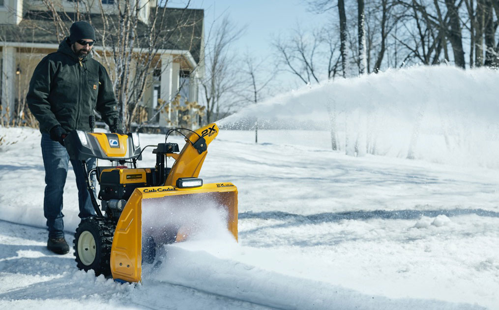 Man snow blowing his driveway