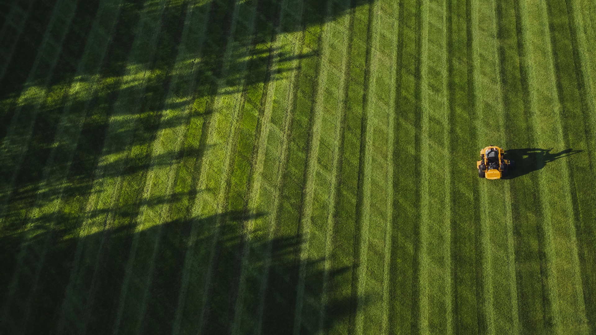 overhead shot of zero turn mower cutting a large space