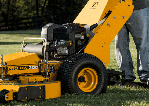 Man standing behind Cub Cadet Pro HW 300 Commercial Walk Behind Mower