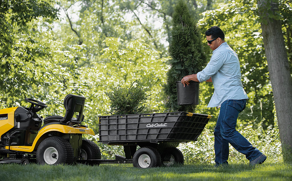 A Canadian tackles yard work with the aid of a Cub Cadet Lawn Tractor