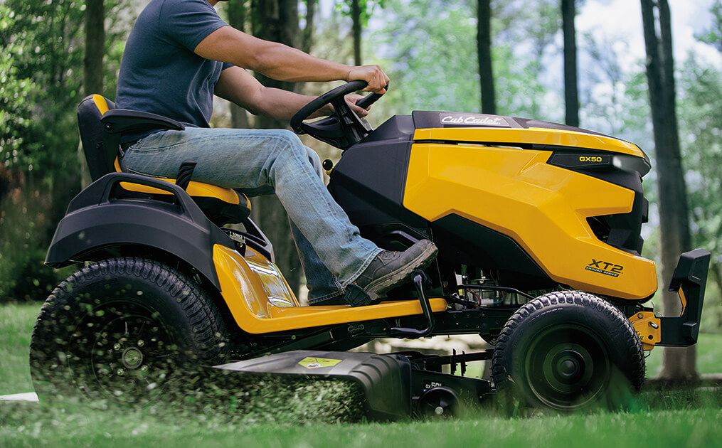 man cutting lawn with new xt2 riding mower