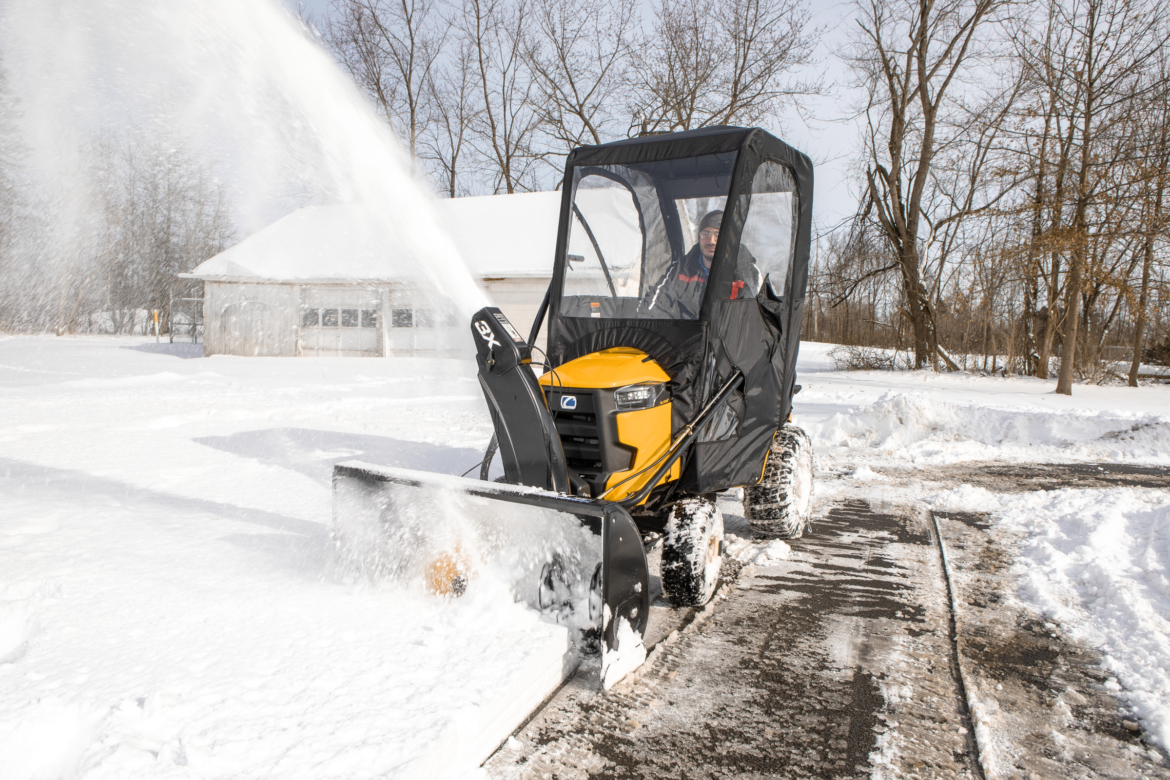Cub Cadet® three-stage snow blower attachment Cub Cadet® three-stage snow blower attachment on an Enduro Series® lawn tractor