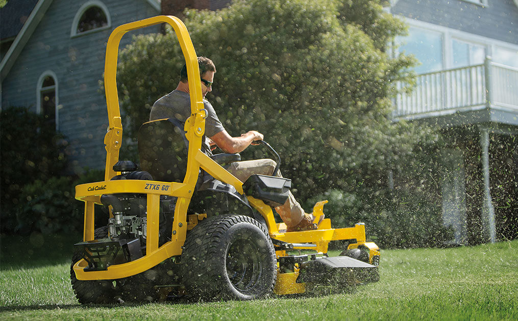 zero-turn mower plowing snow with blade